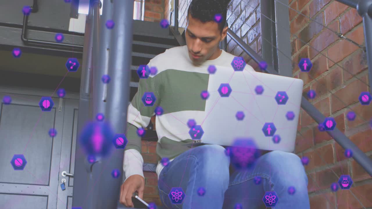 Man typing on laptop on staircase causing network icons and grabbing phone and calling to connect