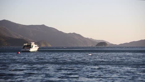 A-white-boat-is-moved-by-the-wind-in-deep-blue-water