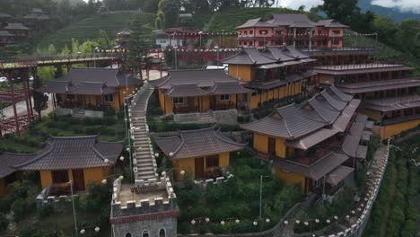 an amazing drone shot of the chinese settlement in tea fields in early morning