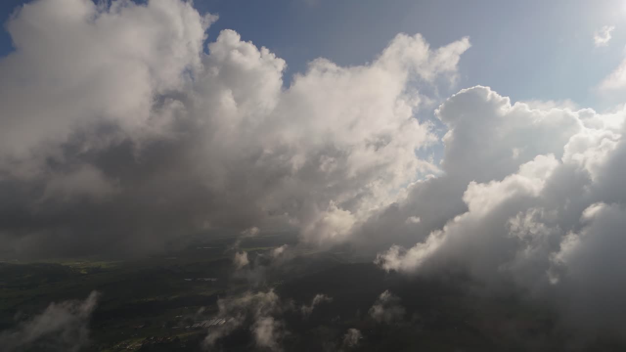 Enjoy the serene beauty of fluffy clouds glowing in the warm sunlight.