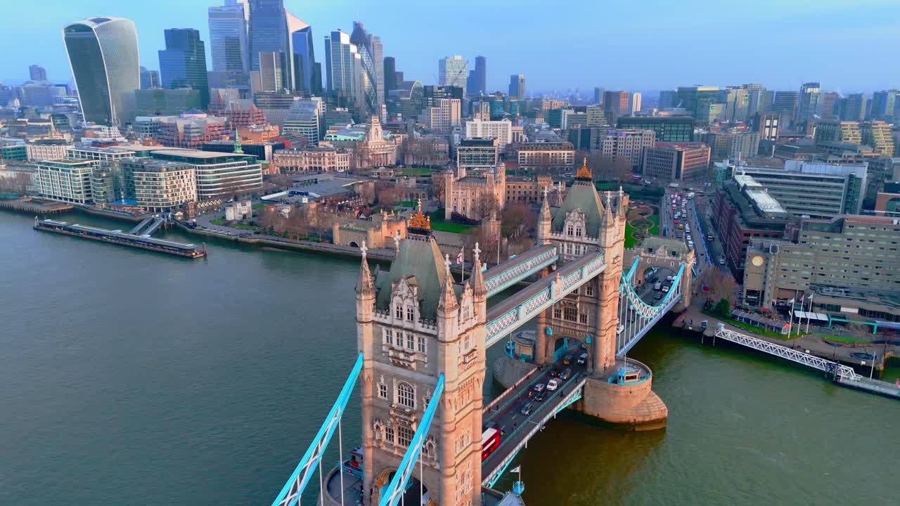 Aerial dolly glides toward Tower Bridge with London rising beyond