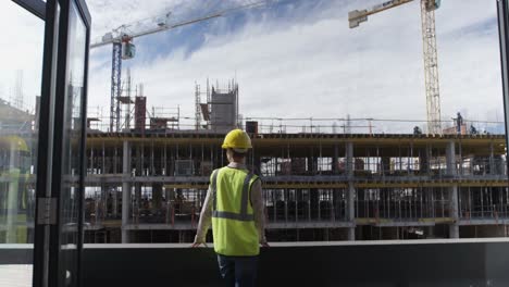 female engineer looking at construction site 4k