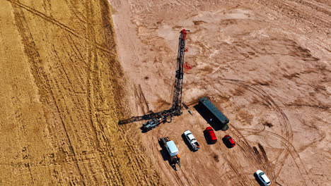 footage around the site for gas production. few cars stand near the truck with high derrick for drilling natural resources. aerial perspective.