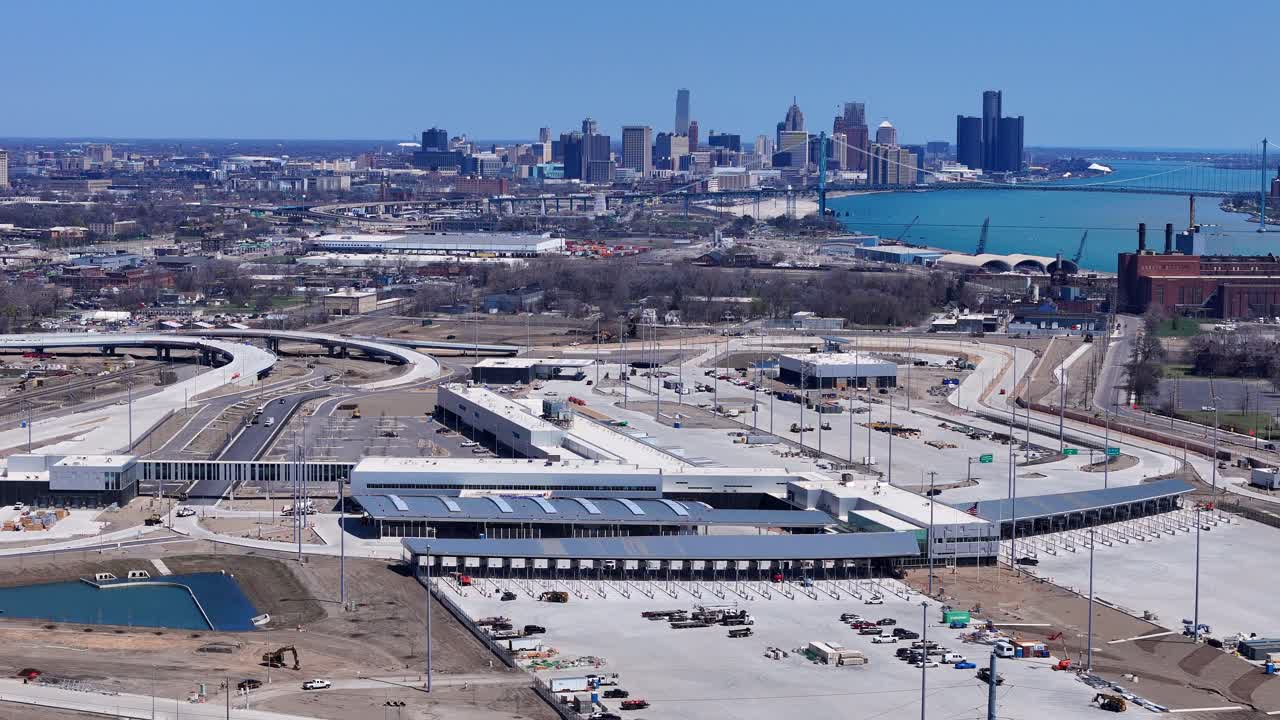 Customs and border facility development with Detroit skyline and river in background