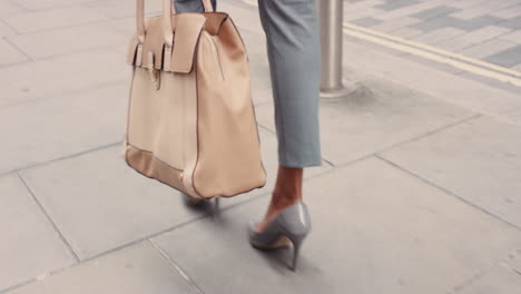 beautiful mixed race business woman's feet walking through city