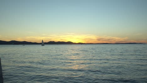 sensational sunset view from zadar in croatia, sailboat on distance, static