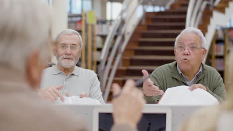 Groups-of-senior-people-disputing-during-class-in-library