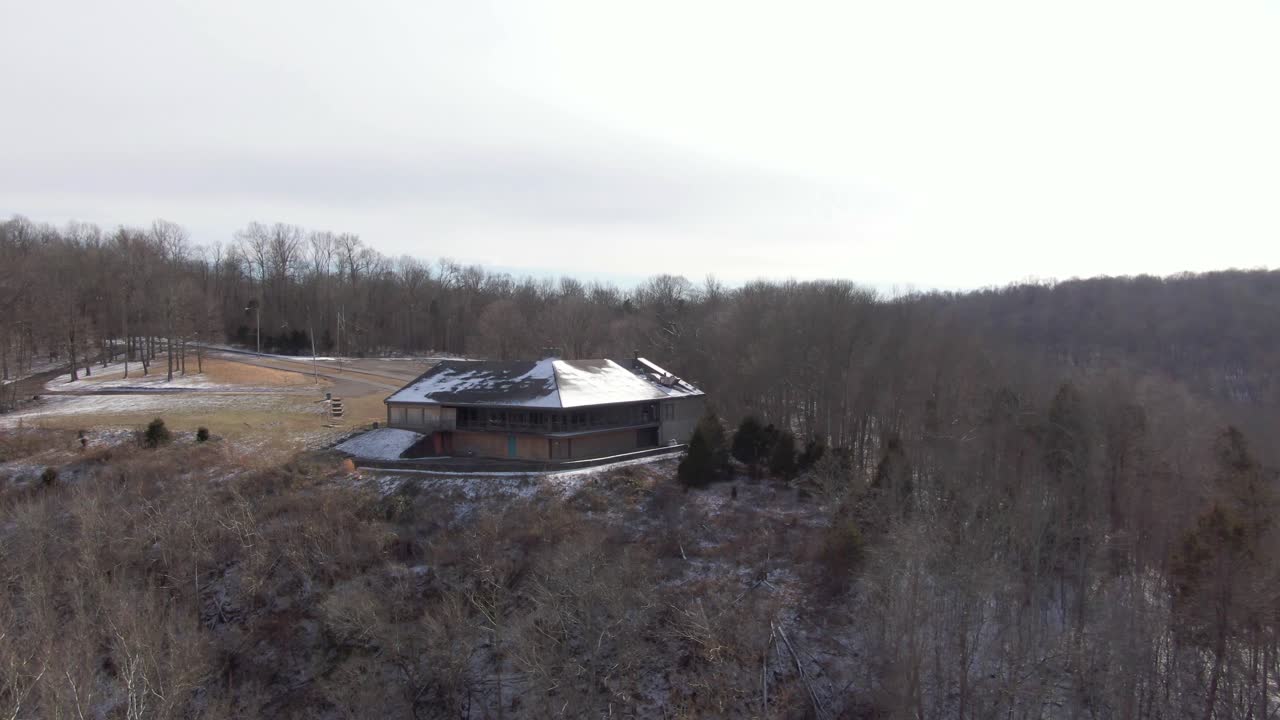 Aerial Drone Footage Orbiting to the Right Around an Abandoned Lodge