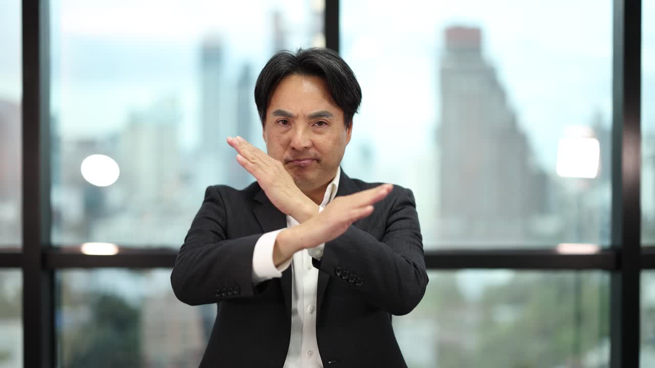 Confident businessman in suit makes crossed arms gesture, natural light, modern office, medium shot