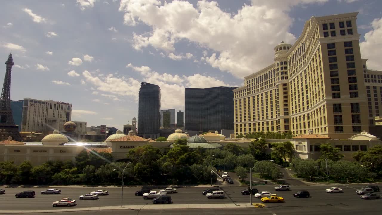 Clouds screaming by the casinos in Las Vegas on a bright summer day, timelapse