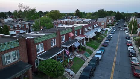 row houses with awnings on a tree-lined residential city street