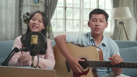 children singing and playing guitar
