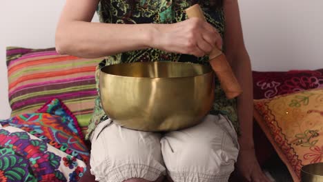 Close-up-of-woman-using-Tibetan-singing-bowl