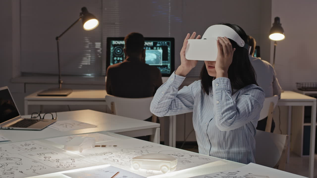 Female Asian Engineer in VR Goggles Working on Project