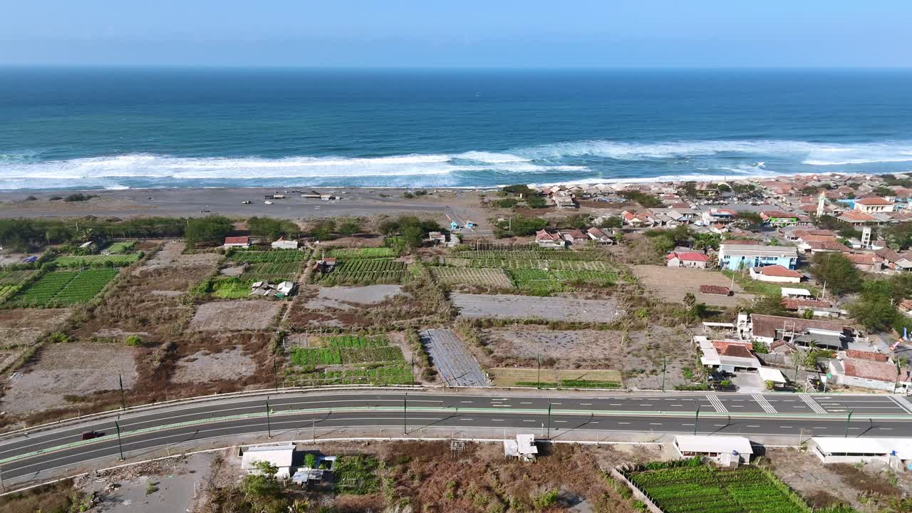 Aerial View of Coastal Village with Farmland and Ocean