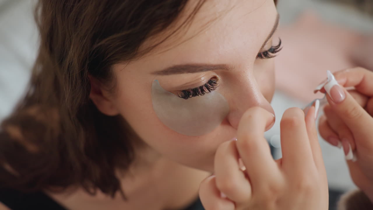 Calm Environment With Attentive Technician Skillfully Placing Enhancements, Serene Spa Setting With Precise Application Of Lash Extensions And Undereye Pads By Experienced Professional