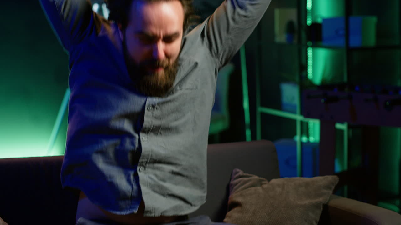 Angry man looking at sports broadcast raging, releasing pent up emotions