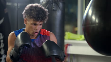 man practicing boxing in a gym