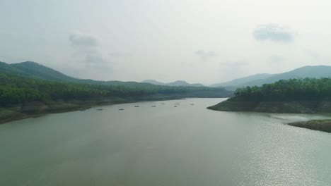 4k-Aerial-View-of-Tranquil-River-Surrounded-by-Mountain-and-Clear-Sky-in-Thailand