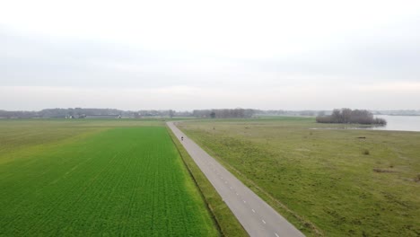 motorcyclist driving towards a drone with landscape background