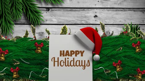 animation of happy holidays text over santa hat and fir trees at christmas
