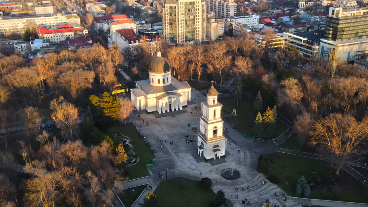 Aerial drone view of Chisinau downtown. Panorama view of central park with bare trees and walking people, catheral, buildings on the background. Moldova