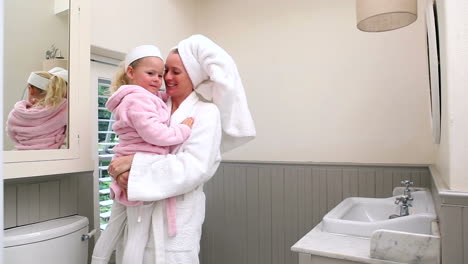 mother and daughter wearing bathrobes