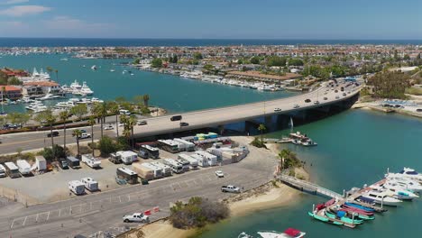 approaching aerial view of bridge and waterway, in newport beach, california