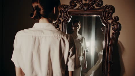 woman gazing into an ornate mirror