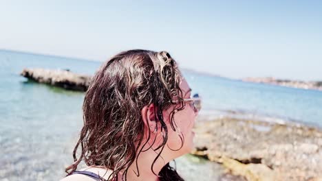 close-up of vlogger enjoying sunny beach day in greece