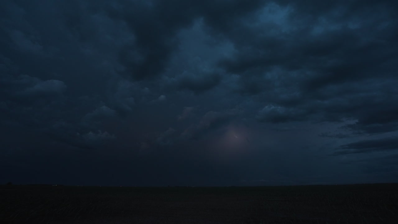 Flashes of lightning from a powerful thunderstorm light up the night sky