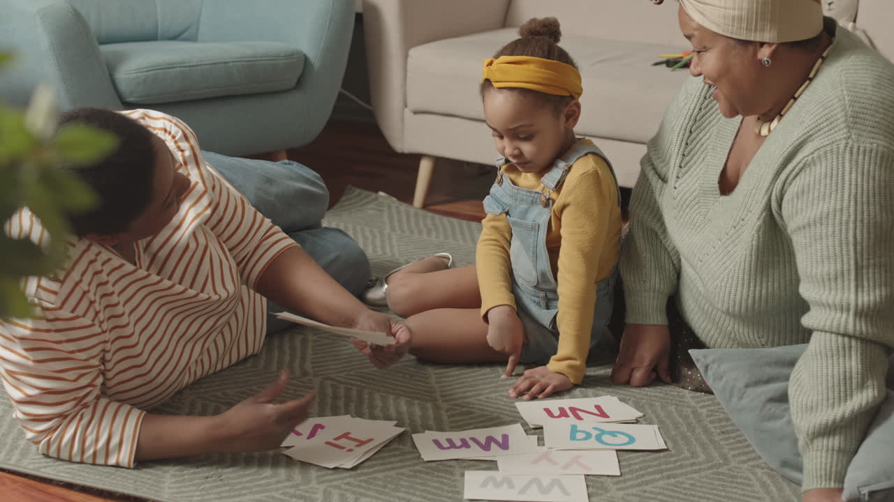 Mommy and Granny Helping Little Schoolchild Learning Alphabet