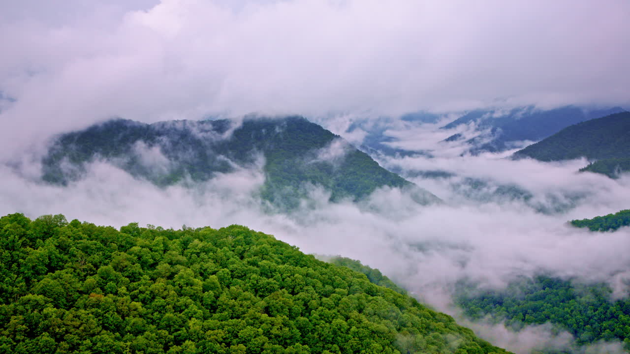 Thick fog rolls over the Smoky Mountains in cinematic aerial view