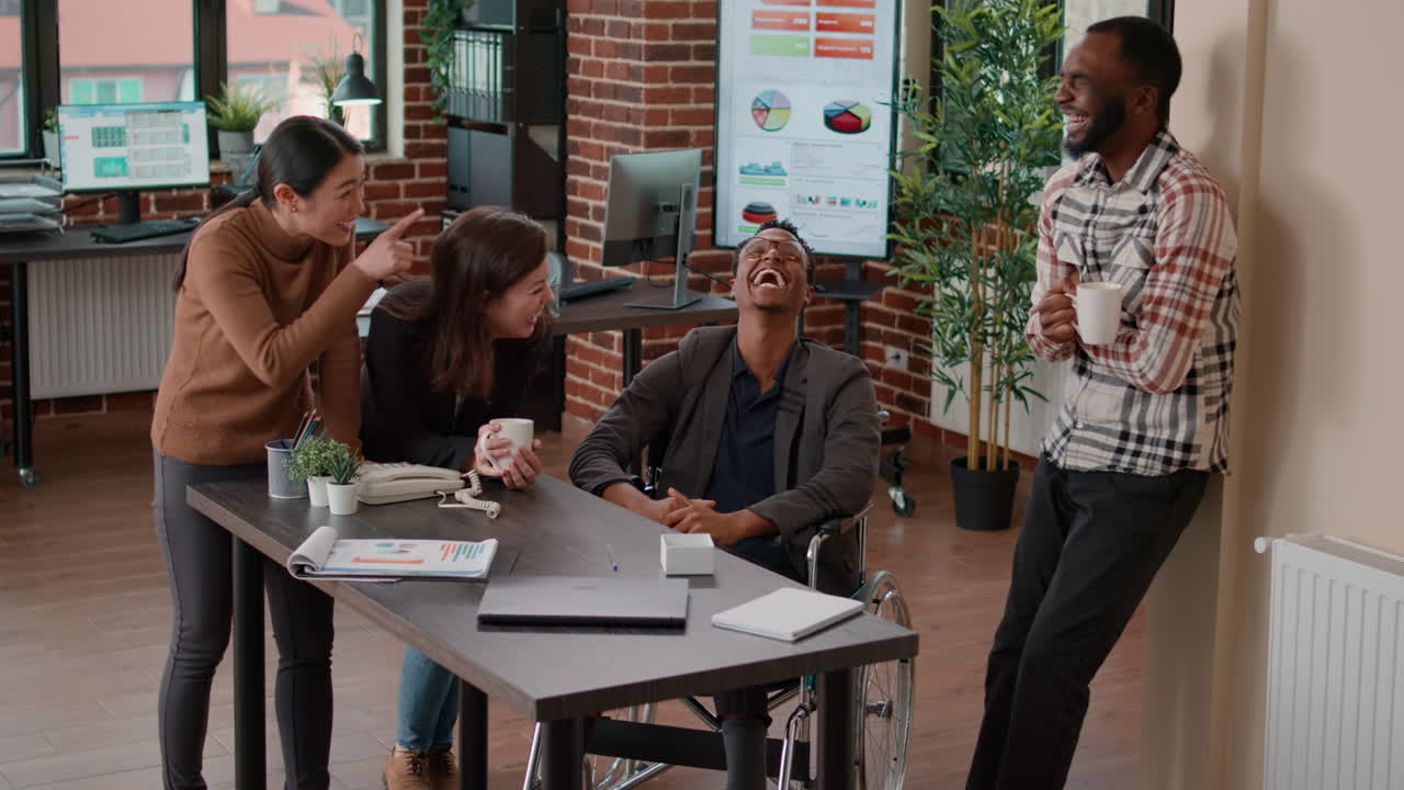 Diverse team of workers laughing together at startup job