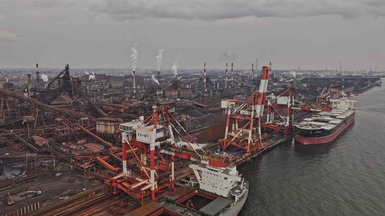Industrial Port with Steel Mill and Cargo Ships Under Overcast Sky