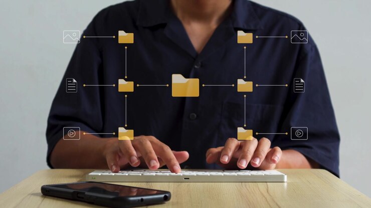 Close-up of hands typing on keyboard with animated central folder hierarchy and media icons