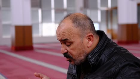 old man raising his hands and praying in the mosque 2