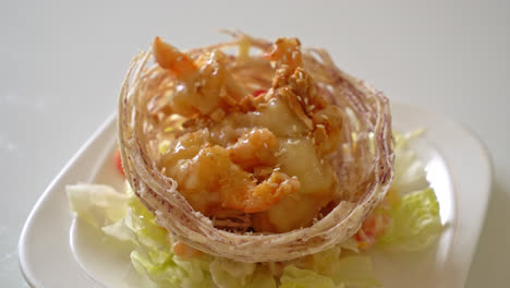 fried shrimp with salad and fried taro basket topped by salad cream and mayonnaise