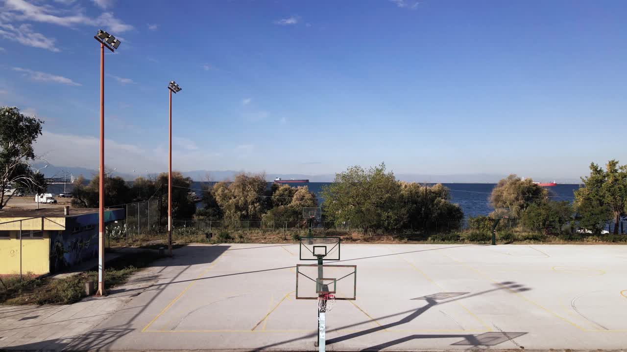 4K drone clip flying ascending over baskeball courts in a sports complex in Thessaloniki, Greece