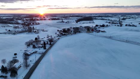 wide high aerial of sunrise in winter snow