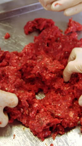 hands of butchers preparing meat ball from minced meat