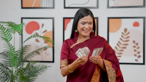 cheerful indian woman counting money