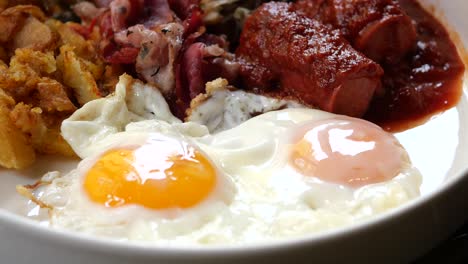 fried eggs with sausage and hash browns