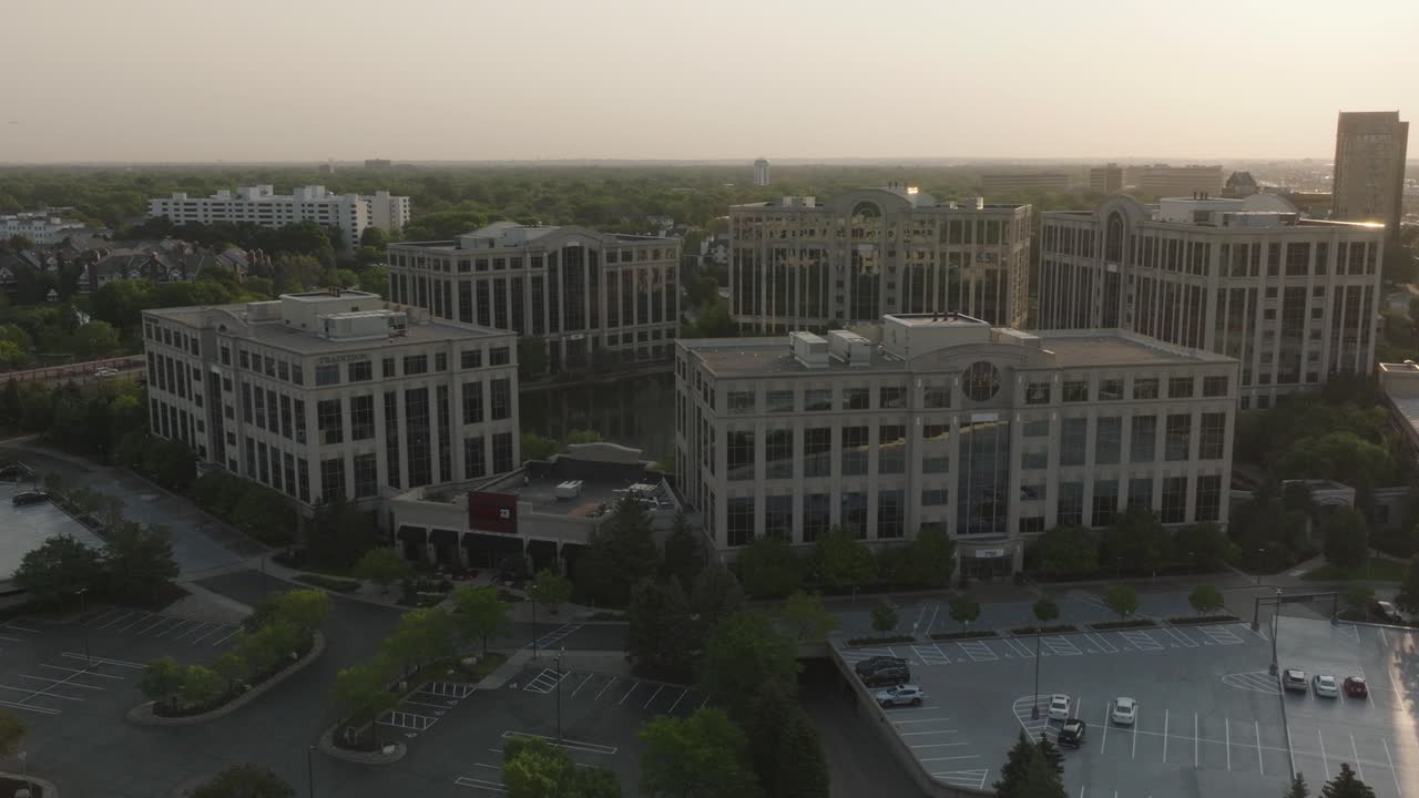 Aerial View of Modern Office Buildings and Parking Lot at Sunset