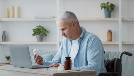elderly man in wheelchair reviewing medication