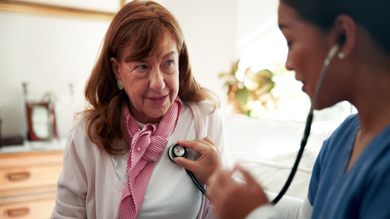 A doctor examining a senior woman with a stethoscope