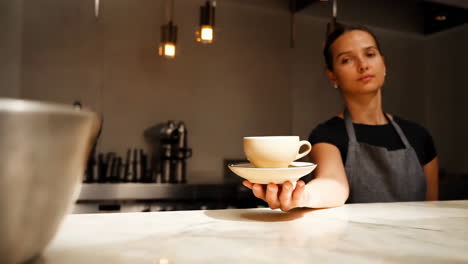 barista serving a cup of coffee