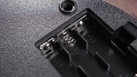 close-up of battery slot of a black electronic device. macro