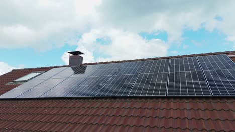 smooth pan reveals solar panels installed on a family house roof, highlighting clean energy