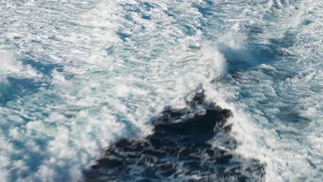 turbulent water trails left by the passing catamaran ferry